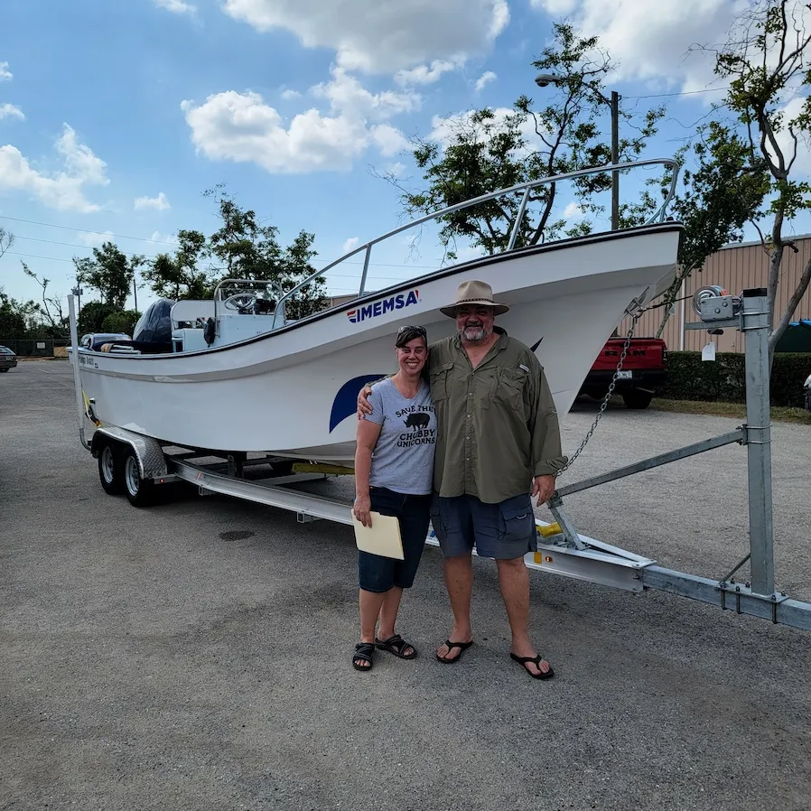 Panga owners with their new IMEMSA hull at the shop
